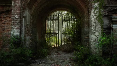 Ruins of an Old European Mansion with Overgrown Entrance and Wrought Iron Gate
