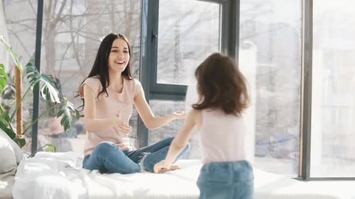 Embracing each other. Daughter congratulates mother with holiday and gives post card