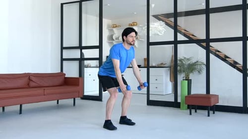 Athletic Motivated Fit Man Doing Bent Over Dumbbell Row Exercise at Home