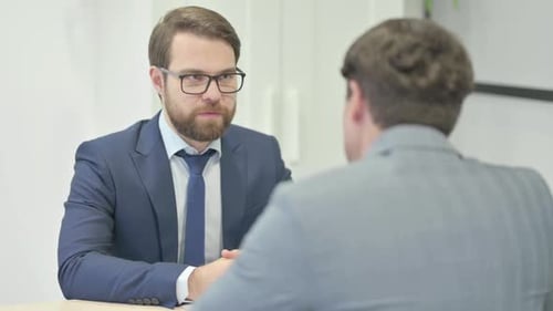 Businessman Talking with Customer in Office