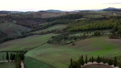 Beautiful sunrise over beautiful hills fields and vineyards of Tuscany, Italy. Aerial view