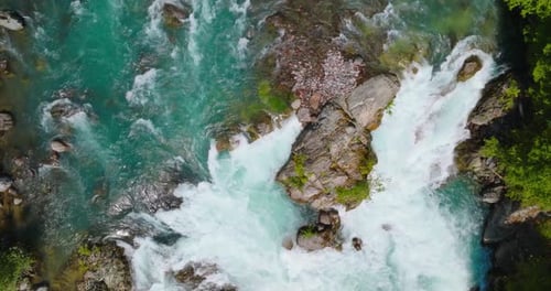 Top Down View of Fast Moving River Surrounded By Pine Forest Canada