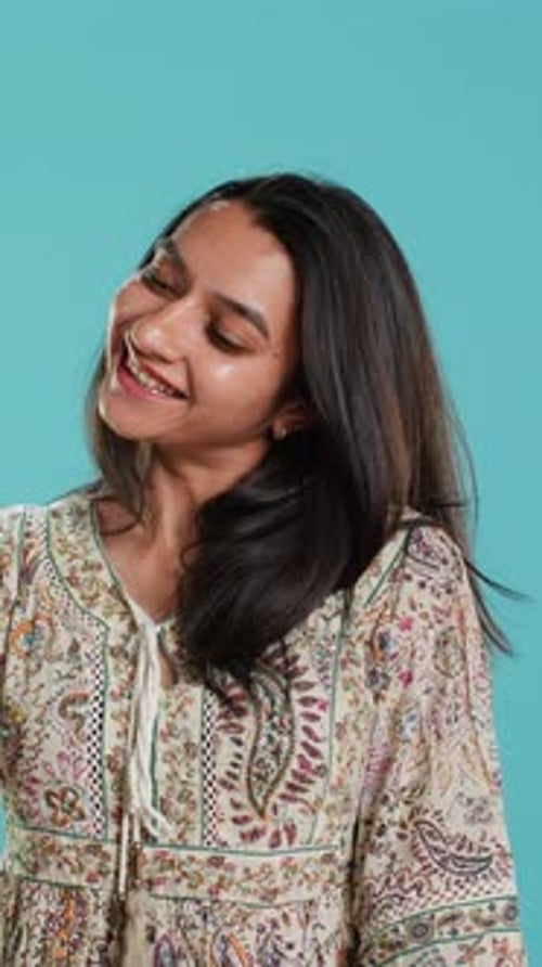 Woman Smiling and Posing in Colorful Dress