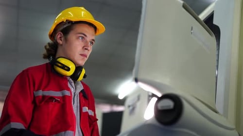 Factory Worker Monitors Industrial Machine