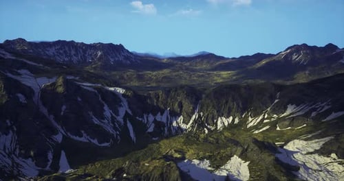 Breathtaking View of a Vast Mountain Range with Sharp Peaks and Lush Valleys