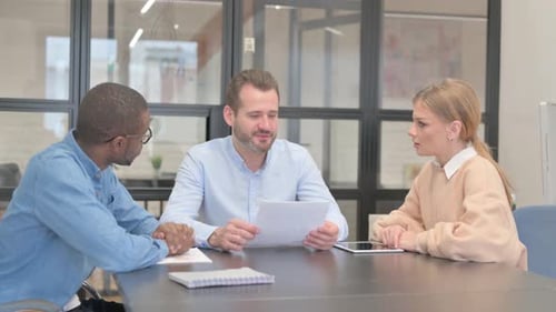 Young Entrepreneur Talking During Meeting in Office