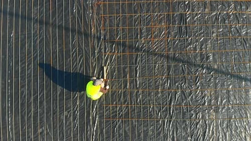 Aerial Shot of Heavy Industry Workers Wearing Helmets and Safety Vests Coworking on Construction