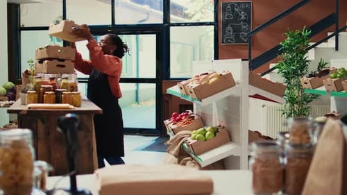 Woman restocking produce shelves in local store