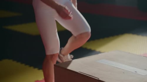 Athlete Prepares to Jump From Box in Gym
