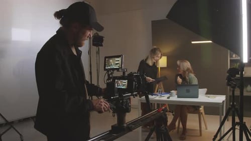 Blogger Talking to Assistant before Filming Show in Studio