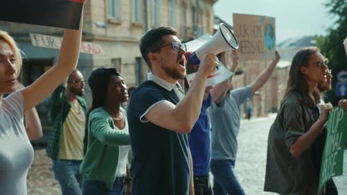 Group Protesting with Signs and Megaphone in City