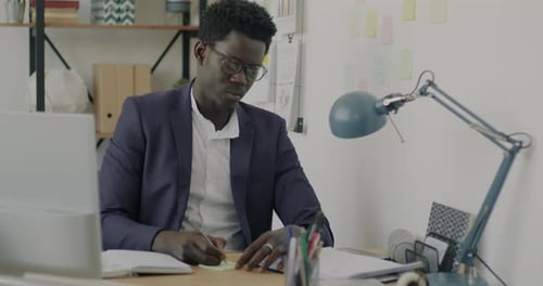 Creative Entrepreneur Writing Memos on Sticky Notes Working in Office Alone