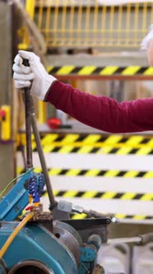 Senior Factory Worker Threading Steel Bar in a Workshop