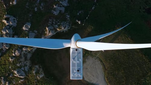 Overhead View Of Wind Turbine With Rotating Blades. - aerial shot