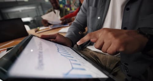 Man Interacts with Charts on a Tablet Device