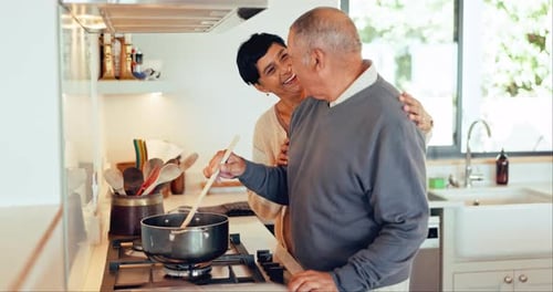 Loving Older Couple Cooking Together at Home