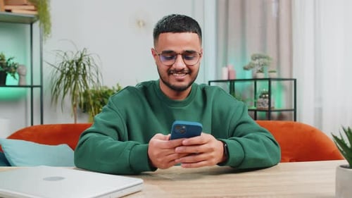 Young Adult Using Smartphone at Home