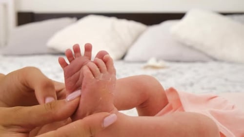 Close Up of Mother Holding Baby's Feet