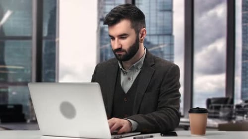 Handsome Hispanic Business Man in Suit Working Laptop Browsing Internet Office Desk Window