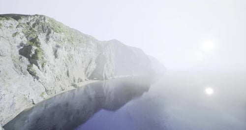 Aerial View Flying Over Rocky Ocean Cliffs and Reflective Water
