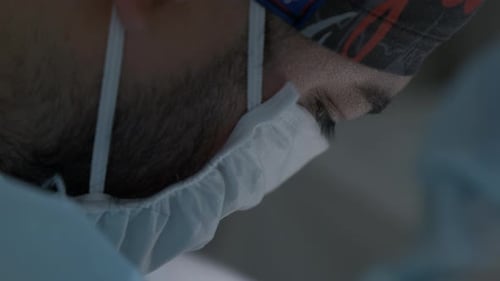 Close up of young surgeon in blue medical mask