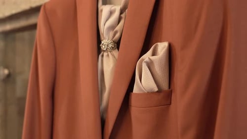 elegant brown suit with silk cravat and pocket square