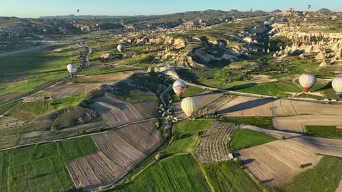 Hot Air Balloons Fly Over the Mountainous Landscape of Cappadocia Turkey