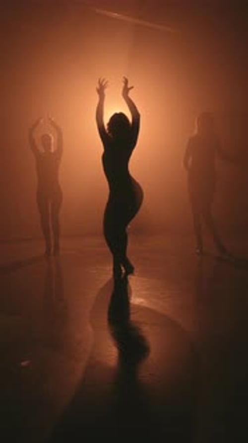 Three Women Dancing in Studio with High Heels Silhouette