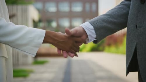 Business Handshake Between Two People in City