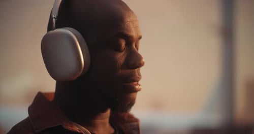Man With Headphones Listening To Music, Golden Hour