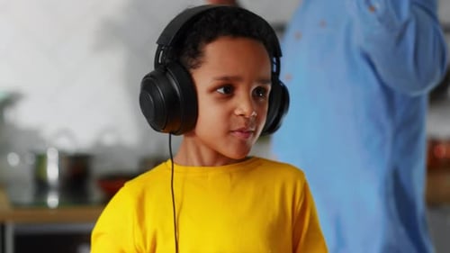 Happy Little Boy DJ Wearing Headphones Performing Music Talented Shaking Head Standing at Sound