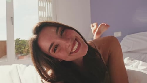 Close-up, happy girl posing lying in bed