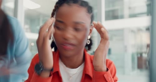 Woman Massaging Temples in Office Experiencing Headache