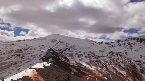 Time lapse snowy mountains and clouds passing at high speed across the sky. Hyperlapse high mountain
