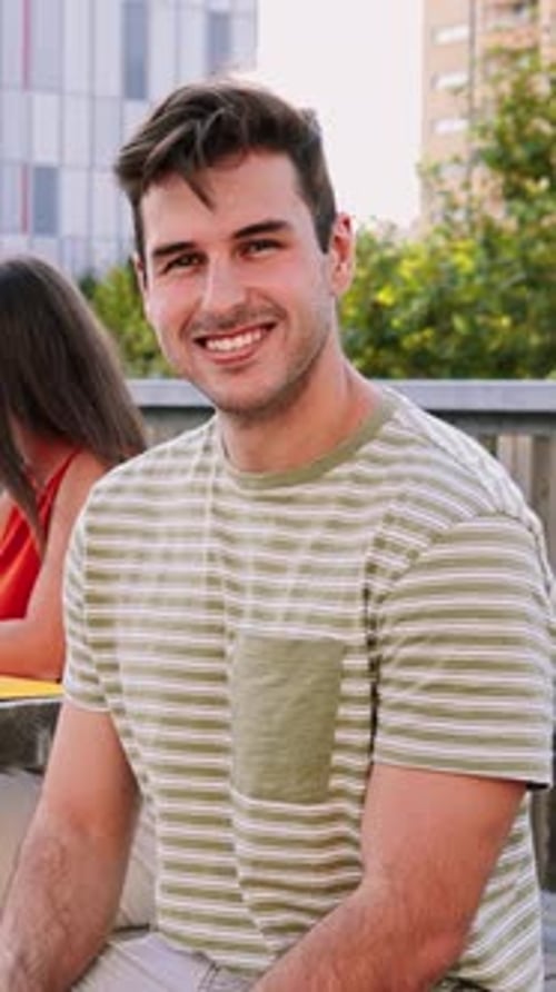 Young Man Smiling At The Camera Outdoors