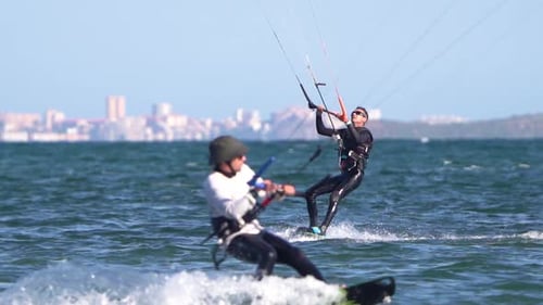 Sportsman practicing kite surf sport at the beach on a windy day at the Spanish coasts