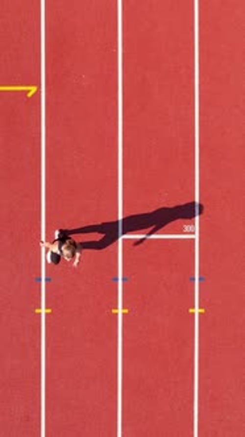 Athlete Runs on Track, Birds Eye View