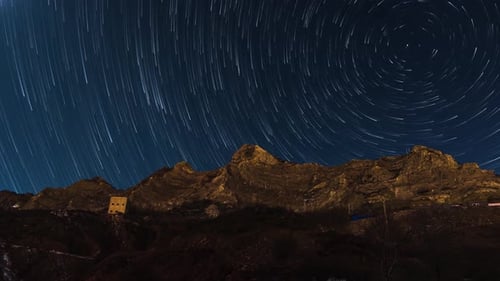 Rotating Star Trails over Mountain Range at Night
