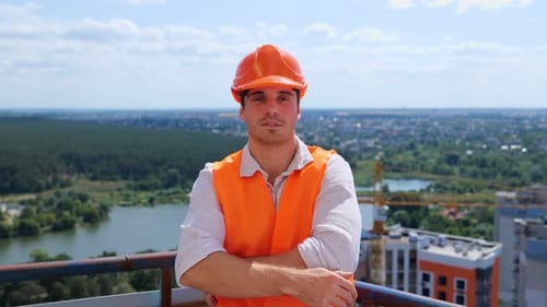 Smiling Construction Worker on a City Rooftop