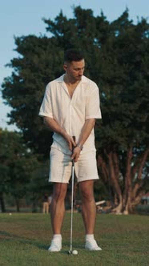 Focused Man Player Hitting Ball with Metal Club on Course Vertical Video