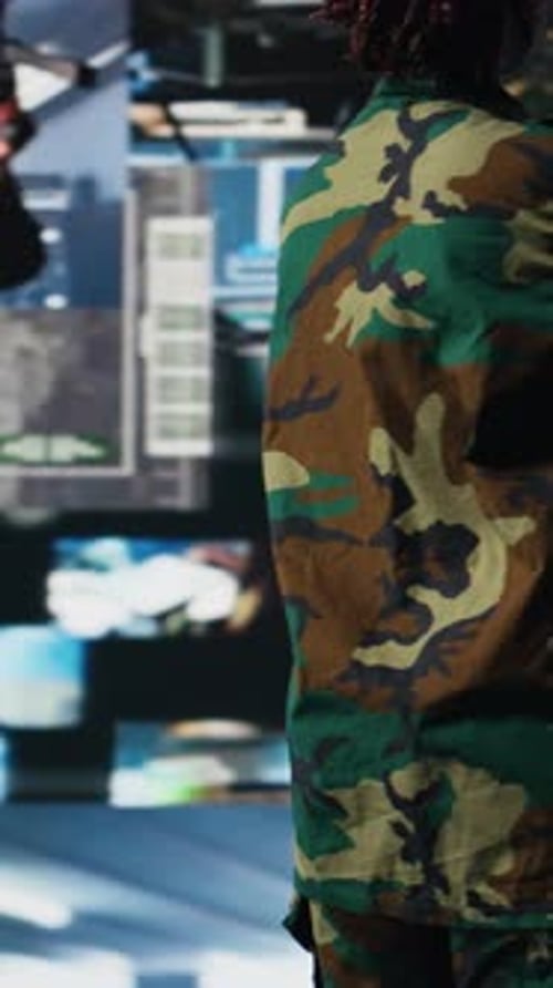 Vertical Video Military Officer in War Room Oversees Mission Operations on Digital Displays