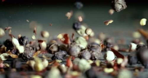 Mixed peppercorns in a super slow motion. Dry mix peppercorns close up.