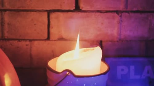 Burning Candle Flame Flickering in Soft Light