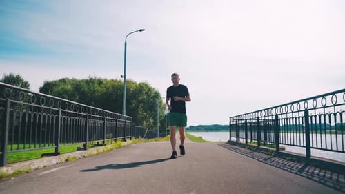 Morning Jog By the Lake Embracing Fitness and Nature Runner Jogging in the Morning Young Man Morning