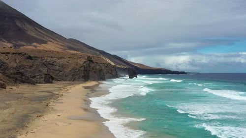 Aerial view of Cofete Beach with Roque del Moro on a cloudy day, Fuerteventura