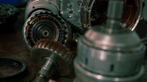 Close-up of the gearbox and clutch of a car taken from a luxury car for repair which lie the table