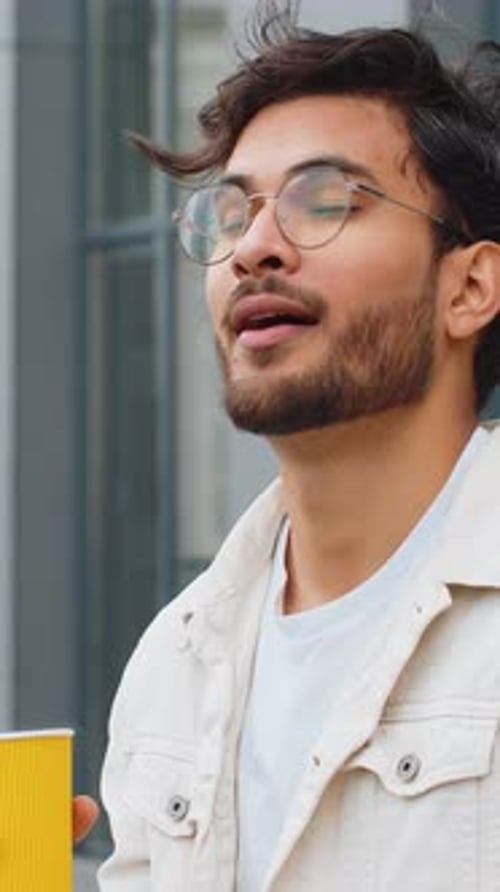 Happy Indian Man Enjoying Drinking Morning Coffee Hot Drink Relaxing Taking a Break in City Street