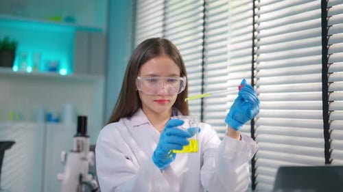 Woman Scientist Working With Liquid in Laboratory