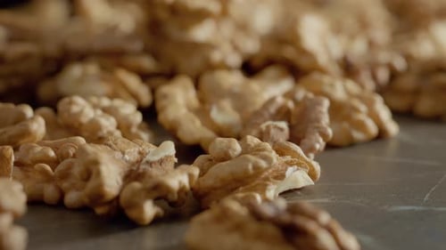 Close Up of Shelled Walnuts on Gray Surface