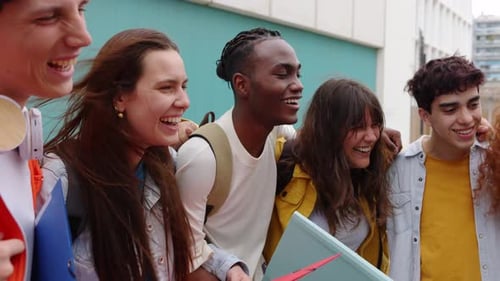 Feliz grupo diversificado de estudantes amigos rindo juntos no campus universitário
